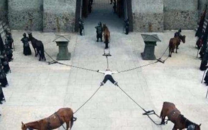 A person stands at the center, being pulled in four directions by four horses tethered to their limbs in a courtyard, illustrating the overwhelming indecision of trying to choose among multiple trendy cryptocurrencies all at once.