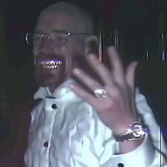 A man wearing glasses and a white shirt is seen grinning widely while flashing a hand gesture, displaying a silver ring and wristwatch. The image humorously captures his excitement over turning 1 Solana into 1.4 Solana, expressing the euphoric reaction of a small crypto gain.