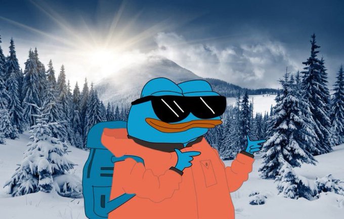 The image features a cartoon frog wearing sunglasses, an orange jacket, and carrying a backpack while standing in front of trees covered with snow. The background shows a snowy mountain landscape under a bright sun. There are no texts or other objects present in the image.