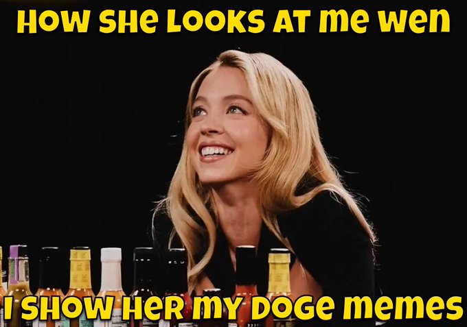 A meme featuring a smiling blonde woman looking up, with text reading 'HOW SHE LOOKS AT ME WHEN' at the top and 'I SHOW HER MY DOGE MEMES' at the bottom.