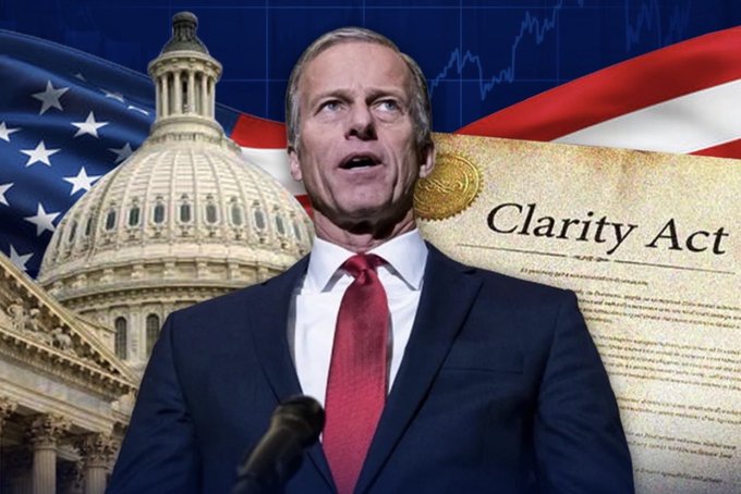 Senate Majority Leader John Thune speaks at a podium, set against a backdrop featuring the U.S. Capitol dome, American flag, stock chart, and a document labeled "Clarity Act," illustrating his push to advance crypto legislation before the Senate recess.
