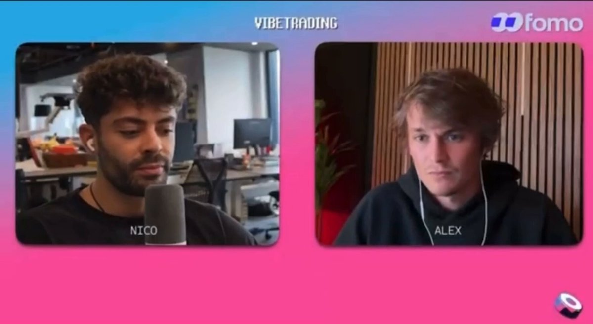 The image shows two men sitting behind microphones during a podcast interview. The man on the left has curly hair, while the other man has straight hair. They are both wearing black shirts. The background of the image features a pink and blue color scheme with white text that reads "vibetrading".