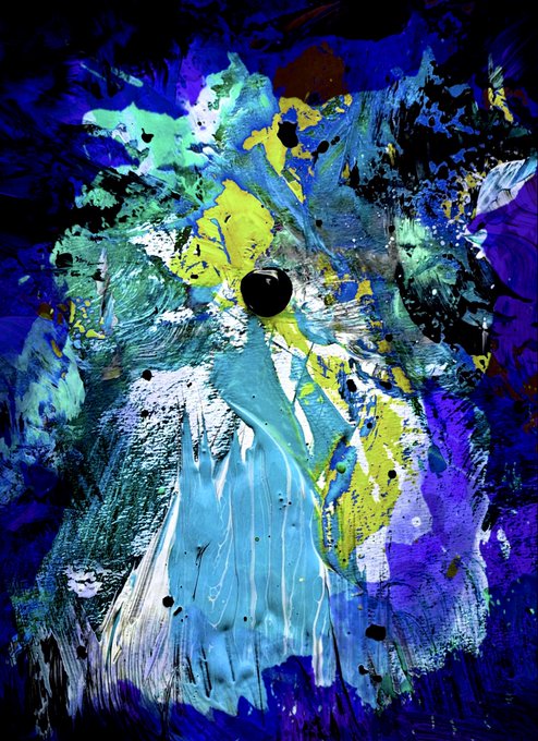 An abstract, heavily textured painting features a burst of blue, purple, green, and yellow hues with a dark sphere at the center.