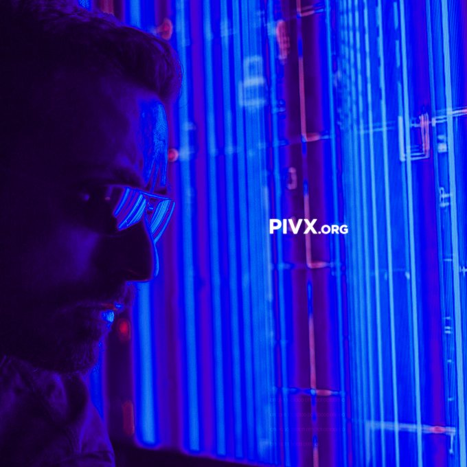 A side profile of a man wearing glasses in blue neon lighting with the text 'PIVX.ORG' displayed.