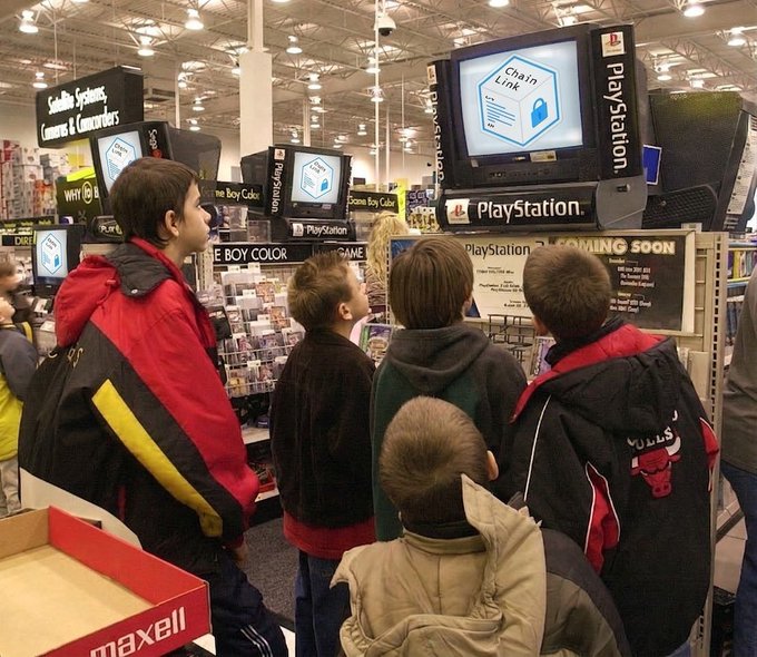 A nostalgic photo of children in winter jackets gathered around a PlayStation display in a store, excitedly watching a screen showing a 'Chain Line' game demonstration with 'PLAYSTATION COMING SOON' signage.