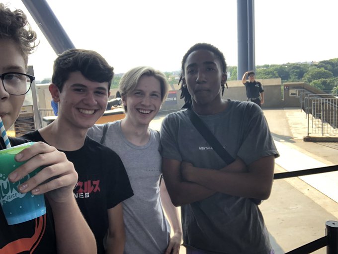 Four friends pose together at what appears to be the ETH CC Paris 2019 conference, with one holding a beverage cup. The image matches the caption's mention of Orangie, Charlie Kirk, Cobie, and Ansem, capturing a candid group moment against an outdoor setting with metal railings visible in the background.