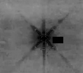 A grayscale close-up image shows a metallic cross-shaped bracket with radiating lines and a black rectangular label against a textured background, visually representing the cryptic token address "FnBB26Dwb4TiuRkb61RhAms1iPauqWAqJ8DyFu9Tpump" as a mysterious "live soon" reveal.