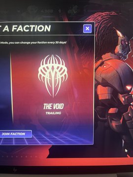 A video game screen showing a faction selection menu titled 'THE VOID' with a masked character in red armor on the right and a 'JOIN FACTION' button on the left.