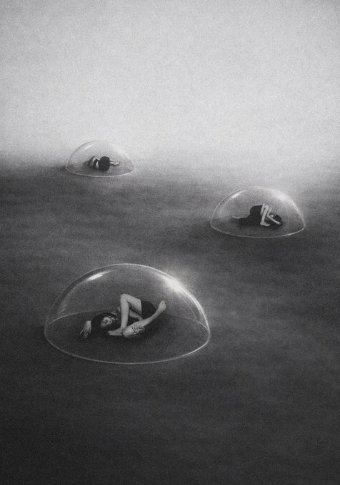 A surreal black and white image shows figures curled up inside transparent domes scattered across a foggy, barren landscape.
