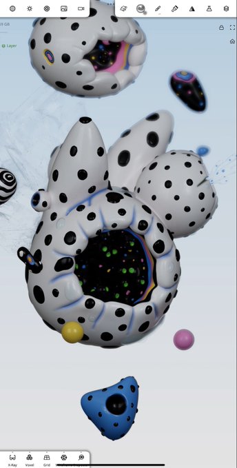 A work-in-progress 3D render in what appears to be Blender (with "Sculpt," "Voxel," "Grid," "X-Ray," and "Layer" tools visible) shows surreal white, black-polka-dotted blob-like creatures with iridescent rainbow edges and colorful confetti-filled openings, fitting the "Gm WIP" morning greeting for an ongoing creative project.