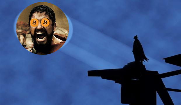 A silhouette of Batman stands atop a structure against a dark blue sky, with a circular inset image showing King Leonidas from the film 300 overlaid with Bitcoin logos covering his eyes. The image pairs with the post's reflection on being an "OG" in crypto, contrasting Batman's watchful vigil with Spartan-era toughness as the author recalls when early crypto success didn't require a social following to "rug."