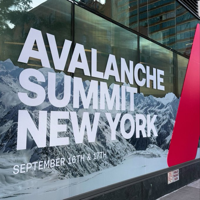 A large street-level advertisement on a building facade reads 'AVALANCHE SUMMIT NEW YORK' over a snowy mountain backdrop, with dates 'SEPTEMBER 16TH & 17TH' and a large red 'A' logo.