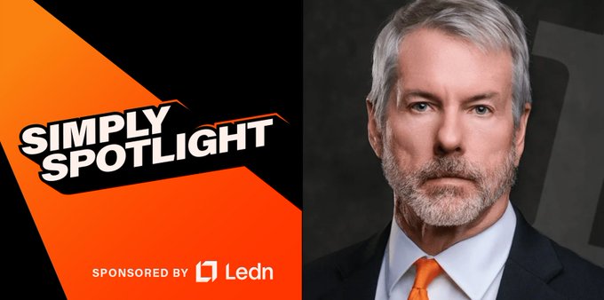 The image features a man wearing an orange tie with gray hair standing against a black background. The text "simply spotlight" is displayed above him, and there are logos for "Lemn" and "48X More Than They Sold".