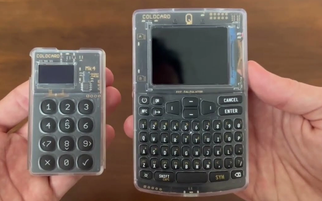 Two COLDCARD hardware wallets are displayed side by side, showing a small numeric keypad model (Mk4) and a larger Q model with a QWERTY keyboard, both featuring transparent casings that reveal their internal components. The image accompanies a post discussing a reported 2026 hack that allegedly compromised these devices, resulting in over $130 million in losses and shaking user trust in hardware wallet security.