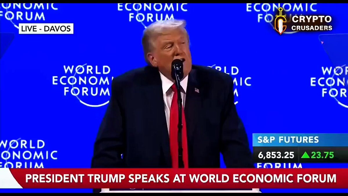 The image shows President Trump speaking at an Economic Forum event. The president is wearing a suit and tie, with his mouth open as if he's speaking into a microphone. The backdrop features a blue banner displaying the World Economic Forum logo, indicating that this event is related to global economic matters. The text in the image reads "JUST INPresident Trump is expected to sign the Digital Asset Market Clarity Act once it reaches his desk, marking a major step forward for U.S. crypto regulation and global leadership in digital assets".