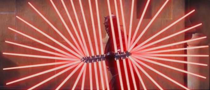 The image features a man standing next to a large number of red lightsaber beams, which are arranged in a fan-like shape with multiple rows and columns. The man appears to be holding one of these lightsaber beams or wearing them as part of his attire. The background is a simple gray color that contrasts with the vibrant red of the lightsaber beams. The image also contains text that reads "x402 just crossed 73M in agent payments these past weeks and ive been tracking thesw onchain flows for 9 months now. the punchline hits when your AI verifies the follow then rugs your bags at 3am while youre still argiong in replies."