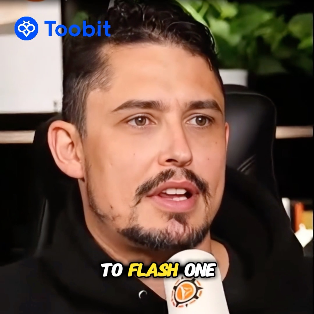 A man with a beard speaks into a microphone with the subtitle 'TO FLASH ONE', with a 'Toobit' logo in the top left corner.