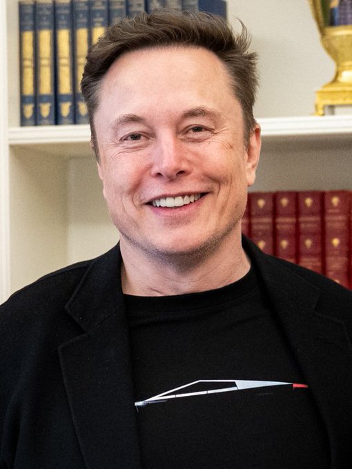 Elon Musk, the world's first recorded trillionaire, is shown smiling broadly while wearing a black t-shirt featuring a graphic of what appears to be a Cybertruck or Starship design, posed in front of bookshelves. The image accompanies a birthday tribute celebrating his 55th birthday and his historic financial achievement.