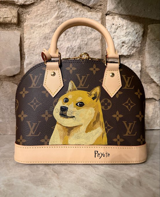 A Louis Vuitton dome-shaped handbag featuring a custom hand-painted portrait of a Shiba Inu dog, with the name 'Peyote' written on the bottom trim, displayed against a stone wall.