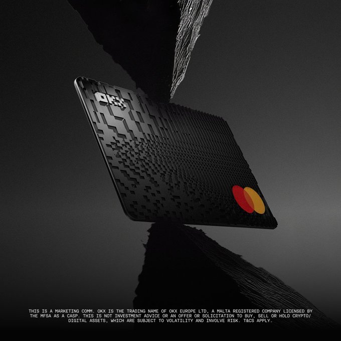 A sleek black OKX Mastercard credit card with a textured geometric pattern is dramatically suspended against a dark, fragmented background, showcasing the orange and red Mastercard logo and the "OKX" branding in the corner. The image complements the post by visually representing the OKX Card being promoted, emphasizing its premium, modern design as the central product offering cashback benefits on everyday spending.