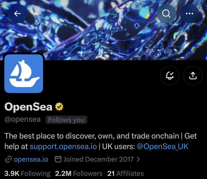 A screenshot of the verified OpenSea Twitter/X profile (@opensea) with 2.2M followers, featuring their blue sailboat logo against a dark water-themed banner. The image directly relates to the post by confirming the follow-back from the official OpenSea account with its gold verification badge.