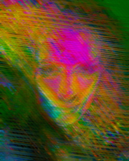 A distorted, glitchy digital image with streaks of green, pink, magenta, and yellow, making the subject nearly unrecognizable.