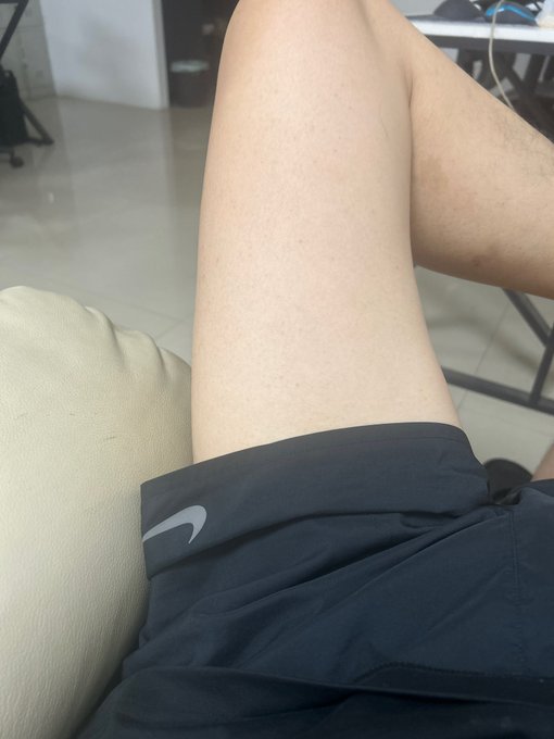 The image shows a person's leg resting on a white pillow while they are sitting or standing. The person appears to be wearing shorts, which could indicate that they are indoors or in a casual setting. The photo does not provide any information about the content of the image or its relation to the post about ads on Twitter.