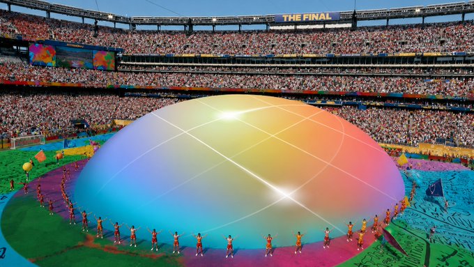A stadium ceremony featuring a large colorful dome with 'THE FINAL' displayed on the scoreboard above a packed crowd.