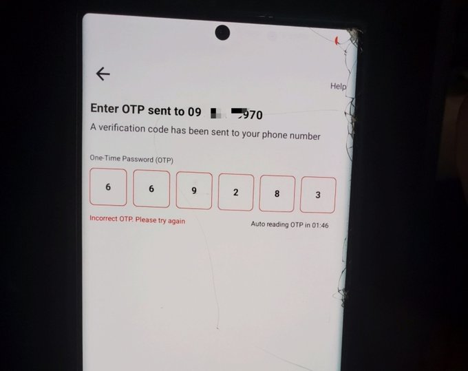 A cracked smartphone screen displays an OTP verification page with the text 'Enter OTP sent to 09 [partially obscured]970' and shows the entered code '6 6 9 2 8 3' along with an 'Incorrect OTP Please try again' message.