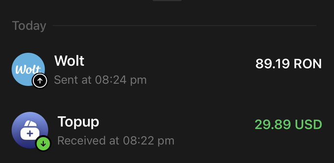 The image shows a screen displaying text from an app named "Wolt" featuring a picture of a blue circle. On this app, there are two notifications about two transactions - one for receiving "Wolt", and another for paying $29.89 US dollars via cryptocurrency. The message also includes an email address or an account name provided by the user to receive more notifications in the future.