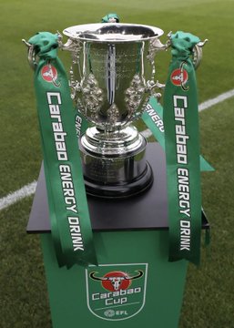 The silver EFL Cup trophy sits on a green pedestal adorned with "Carabao Energy Drink" ribbons and branding, representing the current sponsor. The image relates to the post by illustrating the existing Carabao sponsorship, which Jersey Mike's could potentially replace under a new five-year naming rights deal.