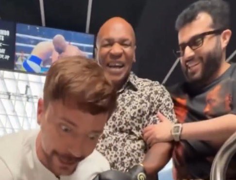 Mike Tyson poses for a laughing photo between two friends, capturing the cheerful mood of a trader celebrating his first MOPEX (monthly options expiration) week, a notoriously volatile trading day.