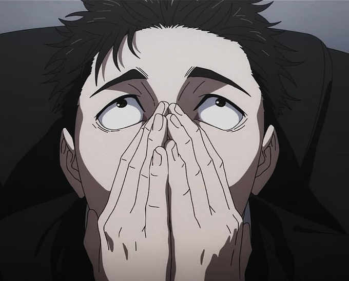 An anime close-up of a dark-haired man with wide eyes and clasped hands, appearing anxious or pleading.