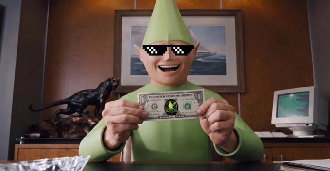 A person dressed as The Mask character (green suit and cone hat) wearing pixelated 'deal with it' sunglasses, holding a prop 'THE UNITED STATES OF AMERICA' one million dollar bill.