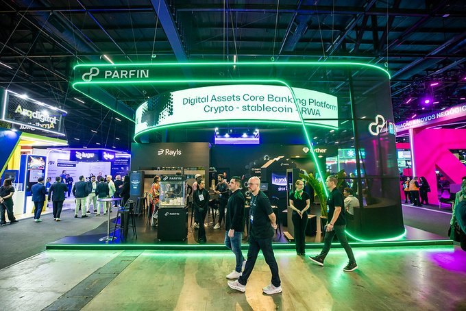 A trade show booth for 'PARFIN' displaying 'Digital Assets Core Banking Platform - Crypto | stablecoin | RWA,' with attendees walking around and green neon lighting.