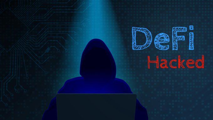 A hooded figure in silhouette using a laptop against a digital background with the text 'DeFi Hacked'.