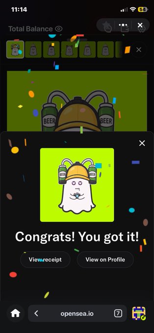 A celebratory OpenSea mobile notification on iPhone displays "Congrats! You got it!" after successfully purchasing a cute cartoon ghost NFT wearing a cap with beer cans, matching the user's post about enjoying buying digital art on their phone via opensea.io.