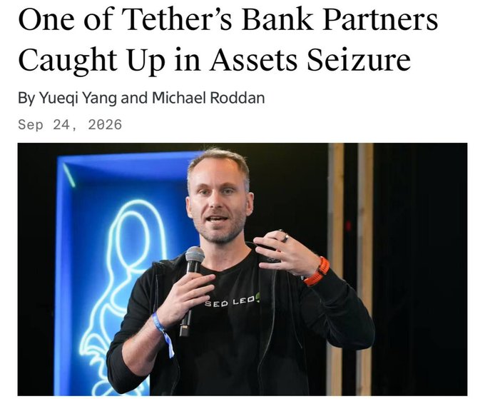 The image shows a news article titled "One of Tether's Bank Partners Caught Up in Assets Seizure" by Yueqi Yang and Michael Roddan, dated Sep 24, 2026, featuring a photo of a man wearing a black "SEED LEO" t-shirt speaking into a microphone at an event with a blue neon-lit background. The article relates to the post by reporting on $84 million in seized funds from accounts at Wells Fargo and JPMorgan belonging to Capstone, a payment company connected to Tether's banking network, with the U.S. Department of Justice pursuing forfeiture.