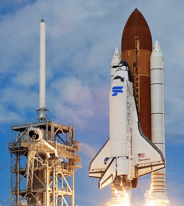 A Space Shuttle Discovery launches from its launch pad with billowing exhaust, featuring the external fuel tank and solid rocket boosters against a partly cloudy blue sky.