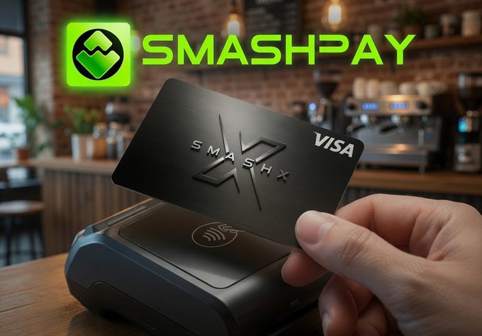 A hand holds up a black "SmashX" Visa credit card near a contactless payment terminal in a cafe setting, with the bright green "SmashPay" logo displayed above. The image visually reinforces the post's announcement about the SmashX Visa Card's cashback rewards program, illustrating the card's sleek design and practical point-of-sale use case for everyday spending.