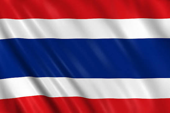 The national flag of Thailand, displaying horizontal stripes of red, white, and blue, waving against a dark background.