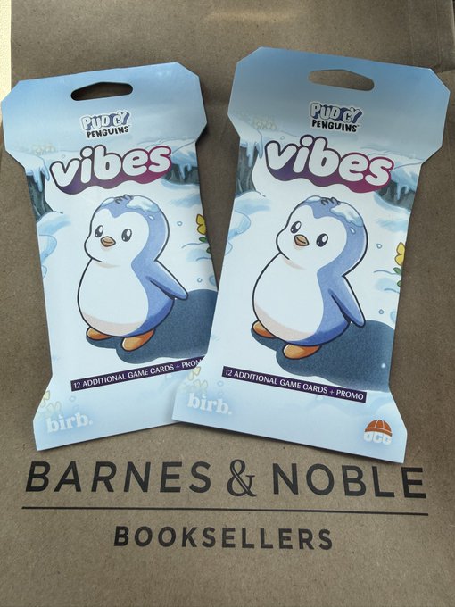 Two "Pudgy Penguins Vibes" card packs, each containing 12 additional game cards plus a promo, are displayed on a Barnes & Noble bag, tying into the post about picking up new Pudgy Penguins collectibles.