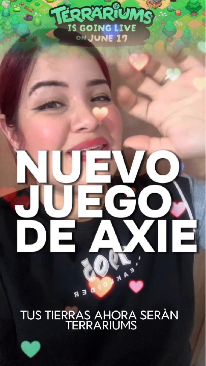 The image features a woman with red hair, wearing a black shirt, who appears to be taking a selfie or posing for a picture at an event related to terrariums. The text "Nuevo juego de Axie" is written above her head and below her shoulder, which translates to "New game on Axie". The image also includes the words "Tus tierras ahora seran", which could be interpreted as "You are welcome here".