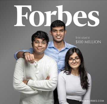 The image features three young men and a woman standing together, smiling for a photo. They are all dressed similarly, wearing white shirts with their arms crossed over their chests. The background of the image is gray, providing a neutral backdrop that allows the colors in the group's attire to stand out. The text "FORBES" can be seen at the top and bottom corners of the image, indicating it is an advertisement for Forbes magazine.