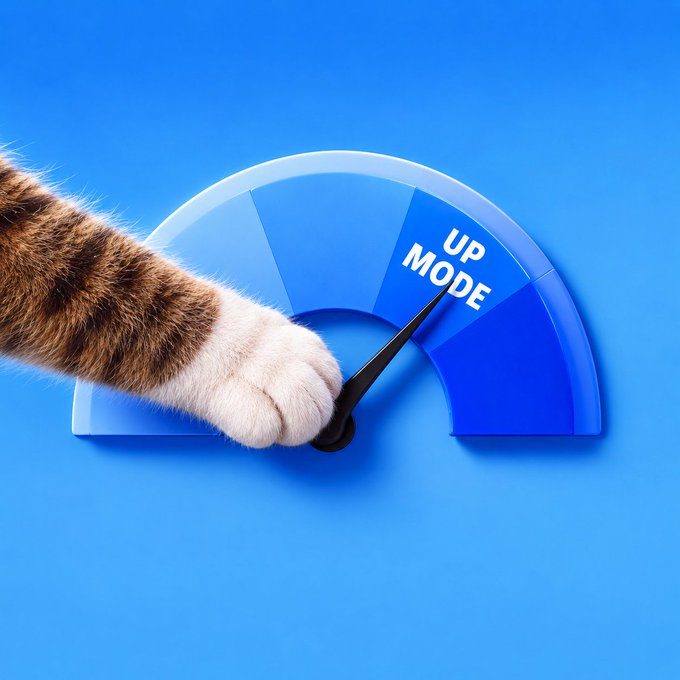 A cat's paw points to "UP MODE" on a blue dial, visually representing the bullish "UPTOBER" optimism. The dial imagery ties perfectly to the post's theme of manifesting one wish as crypto markets shift into a positive momentum.