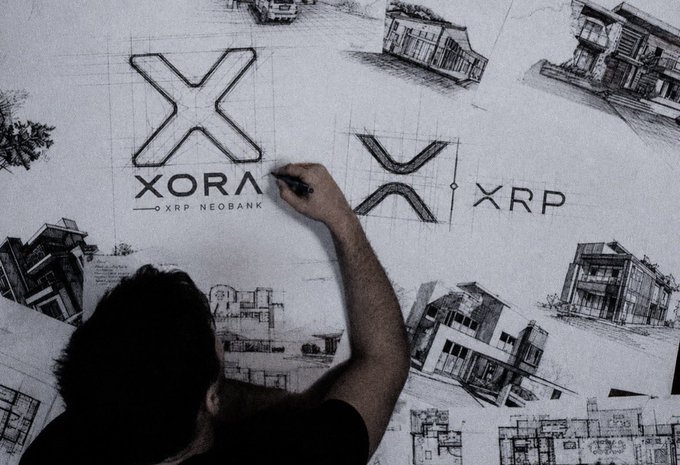 A man sketches out the "XORA XRP NEOBANK" logo, with "XRP" text visible alongside architectural drawings, illustrating the creative development of this XRP-based financial ecosystem.