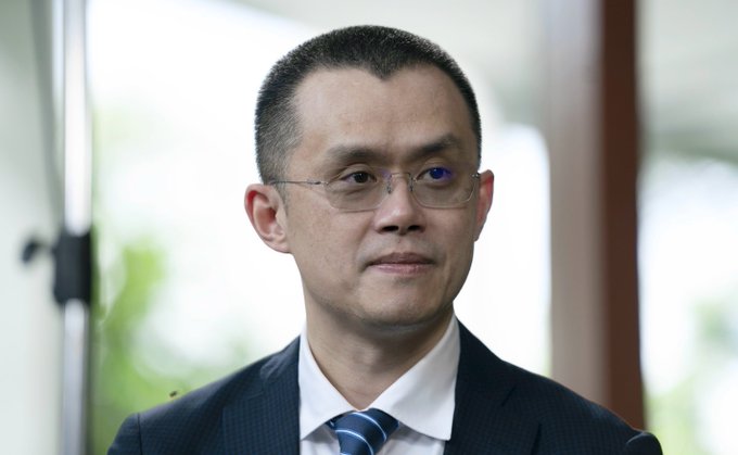 A man in a dark suit, white shirt, and striped tie wearing glasses is shown in a headshot with a softly blurred background. The image appears to accompany a post discussing Binance and regulatory concerns, likely depicting a representative or executive figure relevant to the cryptocurrency exchange industry.