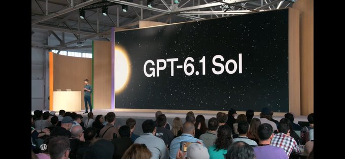 A man gives a presentation on stage in front of a large screen displaying 'GPT-6.1 Sol' alongside an image of a sun against a starry background, addressing a seated audience.