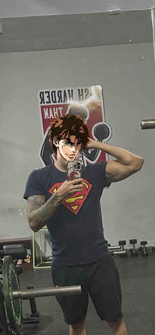 A man takes a gym mirror selfie wearing a Superman t-shirt and flexing his arm, with the text "SH MURDER THAN" visible on the sign behind him. The post caption "gSunday mfers im back into sport mode locked in IRL and in crypto" ties to the image through the Superman "sport mode" shirt and the gym setting, symbolizing his renewed fitness grind alongside his crypto hustle.