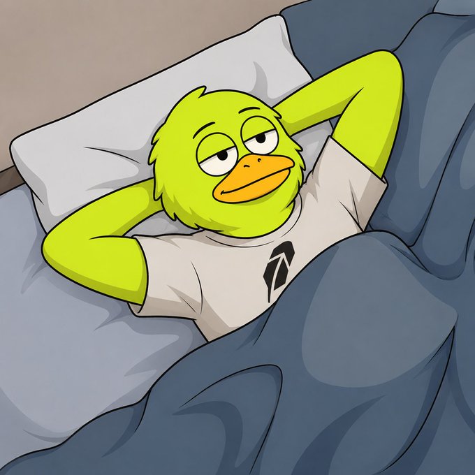 A sleepy green duck character wearing a white shirt with a black "R" logo lies in bed under blue covers, mirroring the post's warning about missing out on Robinhood ("R" logo) opportunities while sleeping. The cartoonish "gn" (good night) vibe matches the character's drowsy expression, suggesting someone catching rest before the next market move.